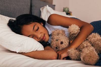 Young woman sleeping on bed at home