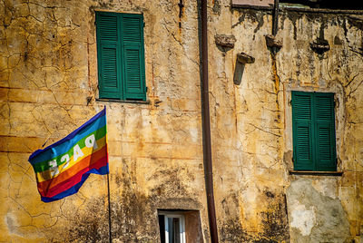 Rainbow flag waving against building