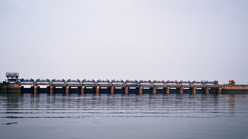 Pier over sea against clear sky