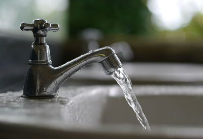 Close-up of water flowing from faucet