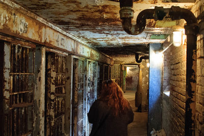 Rear view of woman in abandoned building