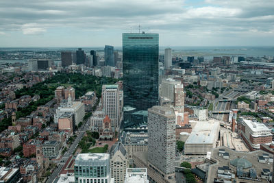 John hancock tower in city against cloudy sky