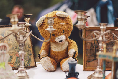 Teddy bear with decorations on table for sale in market