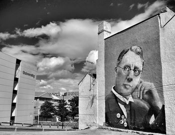 Low angle view of building against cloudy sky