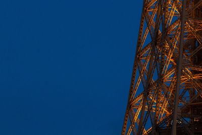 Low angle view of communications tower against clear blue sky