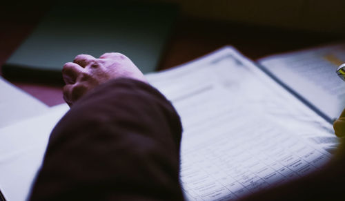 Low section of man reading book