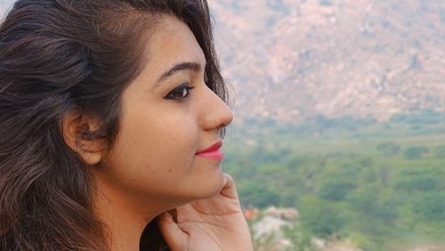 Close-up portrait of young woman looking away