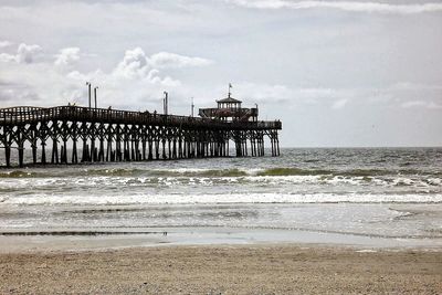 Scenic view of sea against cloudy sky