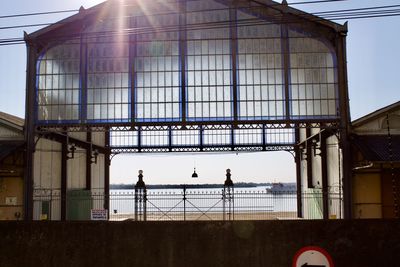 People on bridge against sky