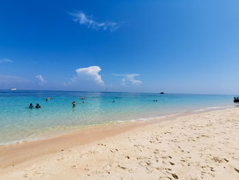 Scenic view of beach against blue sky