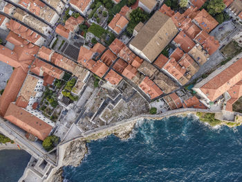 High angle view of buildings by sea