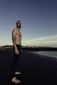 Man standing on shore at beach