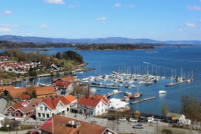 High angle view of town by sea against sky