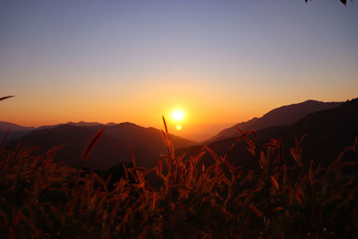 Scenic view of silhouette mountains against sky during sunset