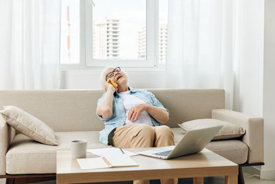 Young woman using laptop at home