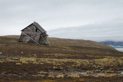 Built structure on field against sky