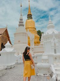 Rear view of woman standing at temple 