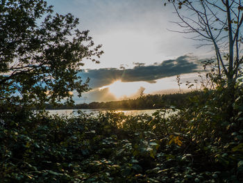 Scenic view of lake against sky at sunset