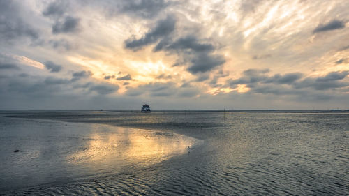 Scenic view of sea against sky at sunset