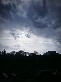 Low angle view of silhouette trees against sky