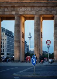 People at brandenburg gate against fernsehturm