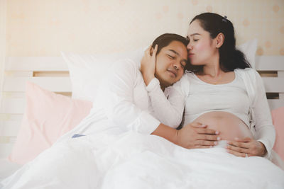 Young couple kissing on bed