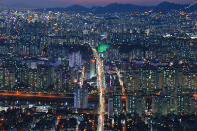 Aerial view of city lit up at night