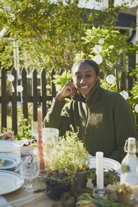 Smiling woman at table in garden