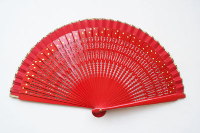 Close-up of red umbrella against white background