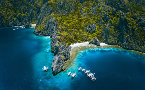 High angle view of outriggers moored in sea