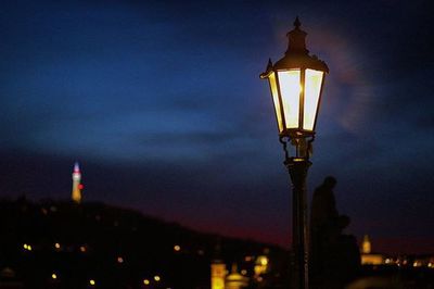 Low angle view of illuminated street light at night