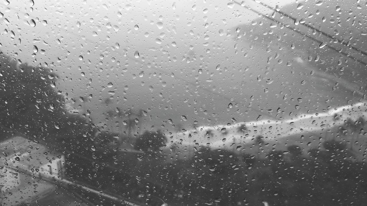 VIEW OF RAIN DROPS ON GLASS WINDOW