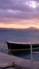 Pier on sea at sunset