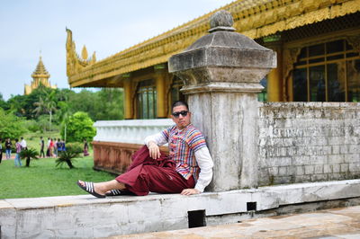 Full length of man sitting outside temple