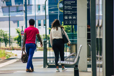 Rear view of people walking in city