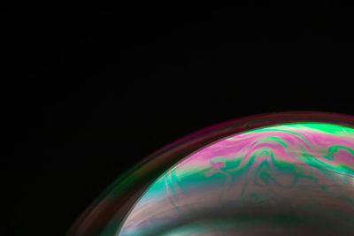 Low angle view of bubbles against black background