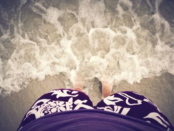 Low section of woman standing on tiled floor