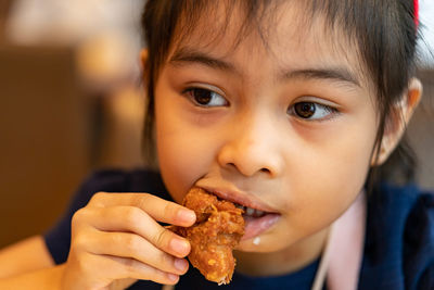 Close-up portrait of boy eating food