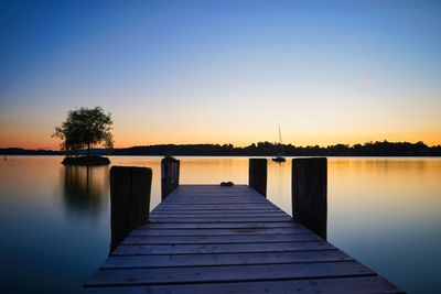 Pier over lake against sky during sunset - frauenchiemsee