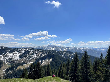 Scenic view of snowcapped mountains against blue sky