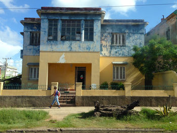 Full length of woman standing against building