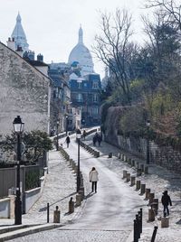 People walking at temple against sky