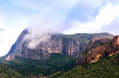 Scenic view of mountains against cloudy sky