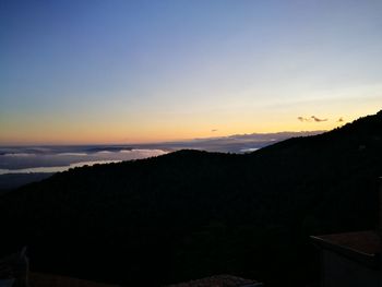 Scenic view of silhouette mountains against clear sky