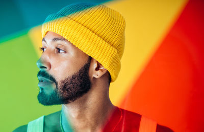 Portrait of young man against yellow background