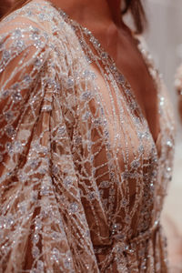 Elegant fashion details of pastel pink haute couture boudoir dress with glitter. fashion shot