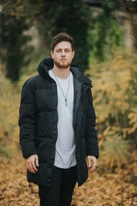 Young man standing in forest