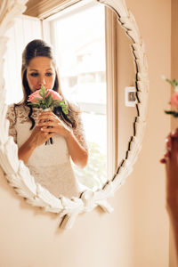 Portrait of woman holding white flowers