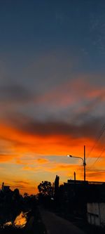 Silhouette buildings against sky during sunset