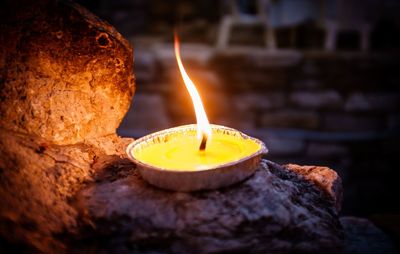 Close-up of lit candles in temple